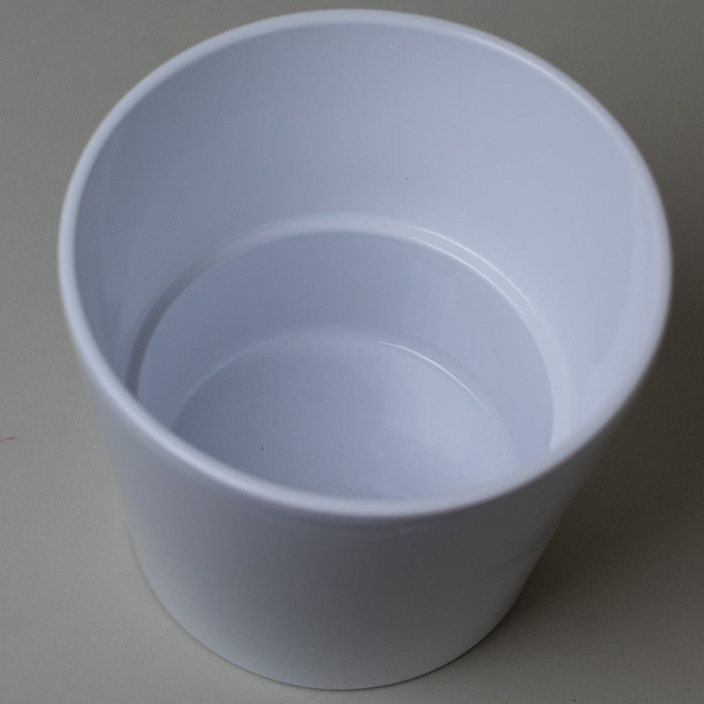 Indoor houseplant pots shown from above, featuring a white ceramic plant pot with smooth interior, ideal for indoor planting.