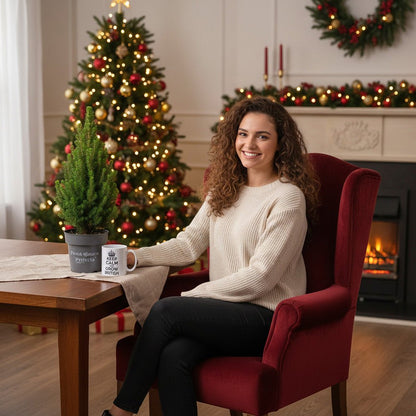 Compact Picea Glauca Perfecta dwarf spruce tree next to a lady sitting in a festive living room.