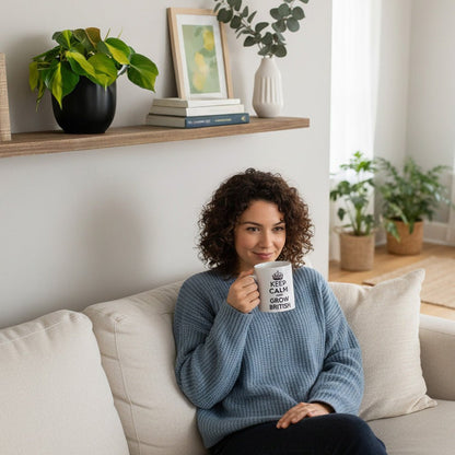 Woman sitting on a couch holding a mug with Pothos Plant and decor in the background